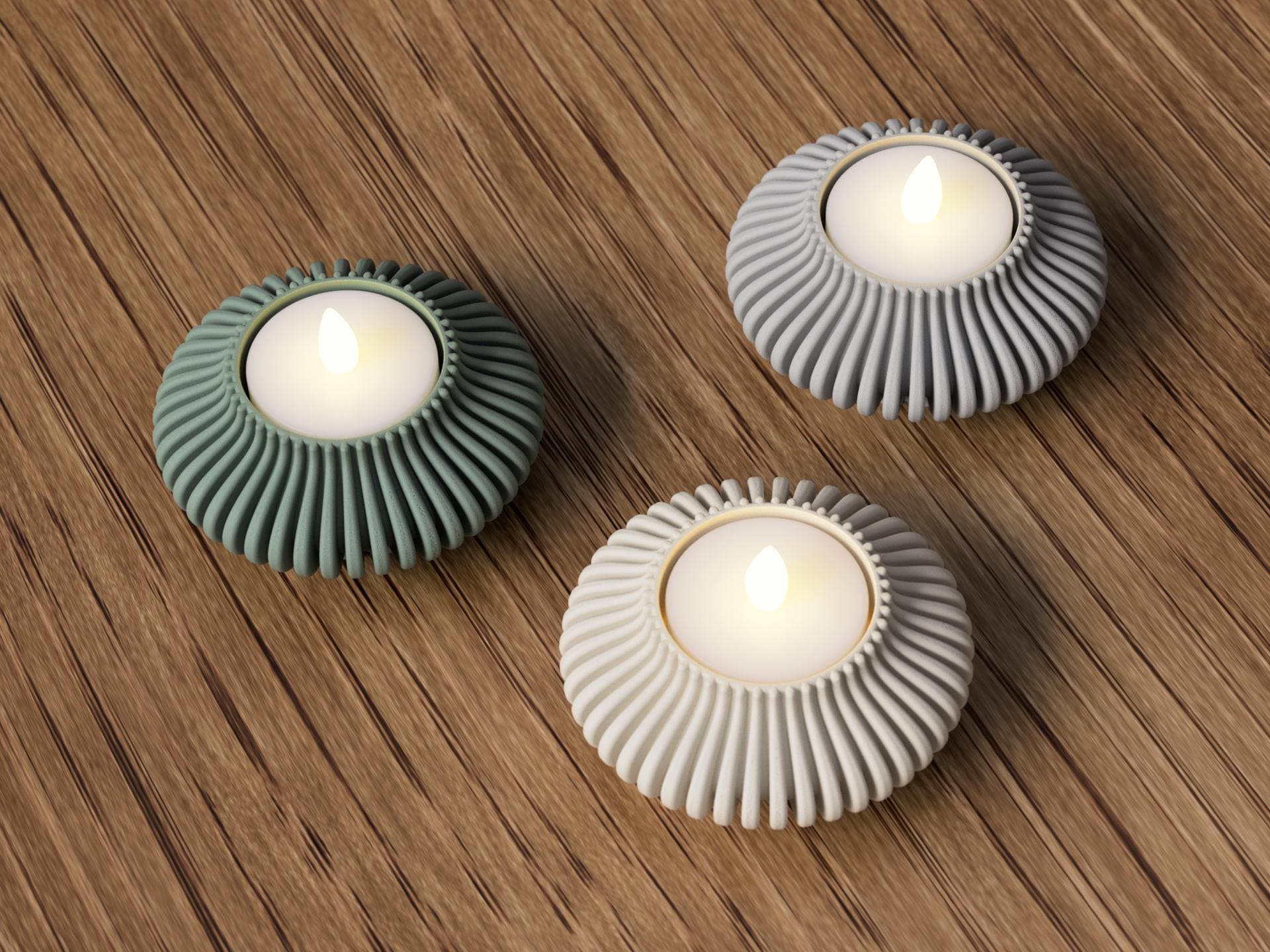 Tre portacandele Japandi a coste in PLA con lumini LED, nei toni verde, grigio e chiaro, visti dall'alto